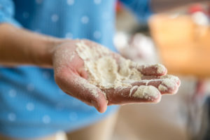 A hand holding newly milled flour